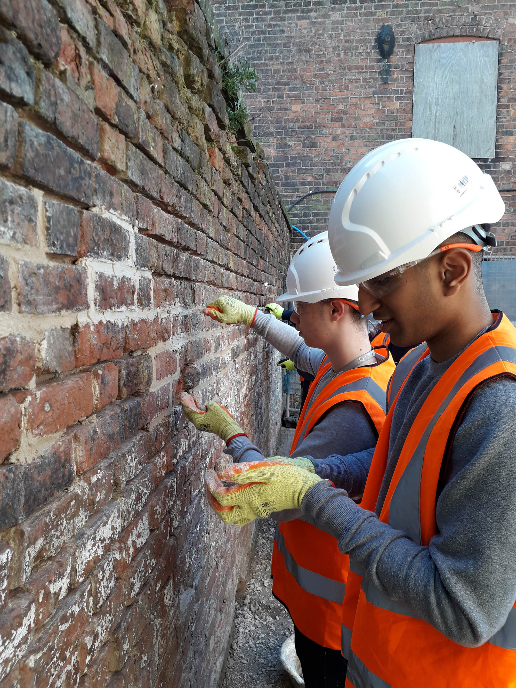 Construction students had a practical session in using traditional lime mortar for repointing.