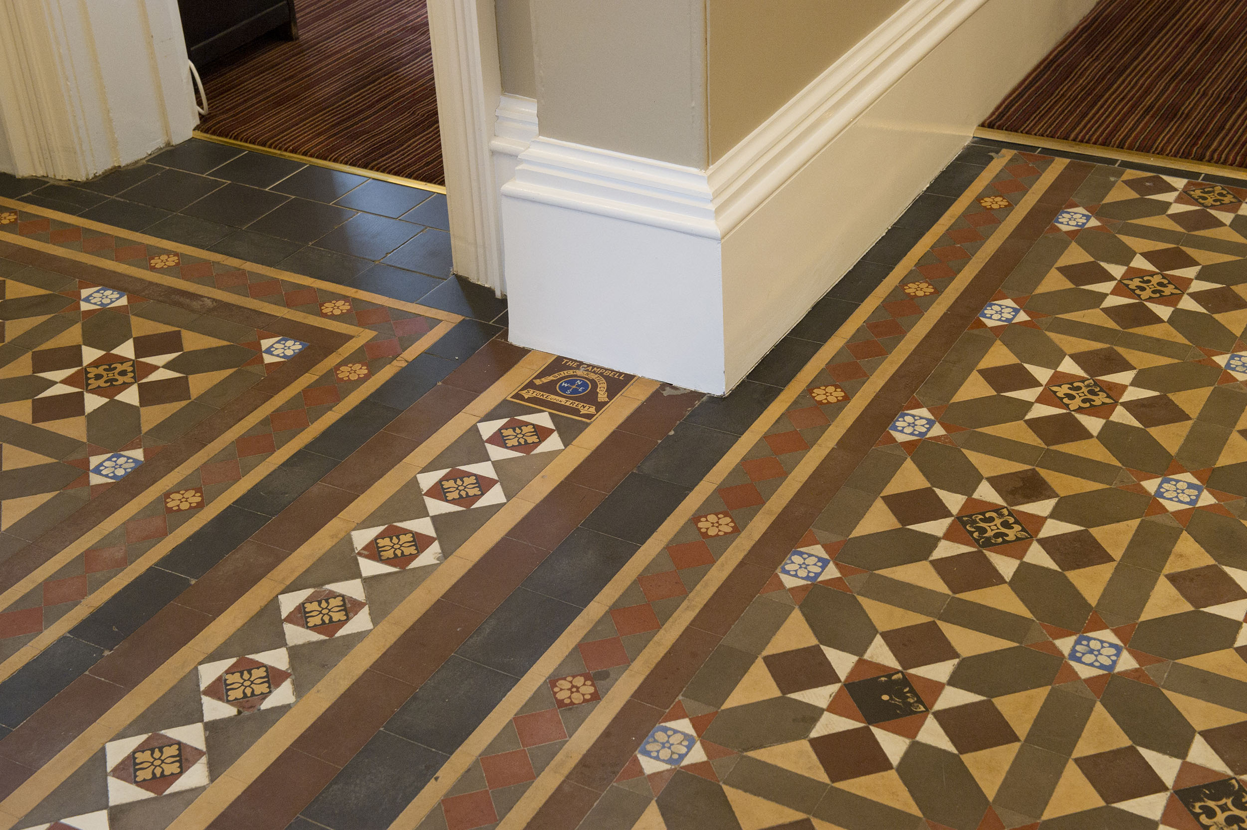 Image of historic floor tiles set out in an intricate pattern.