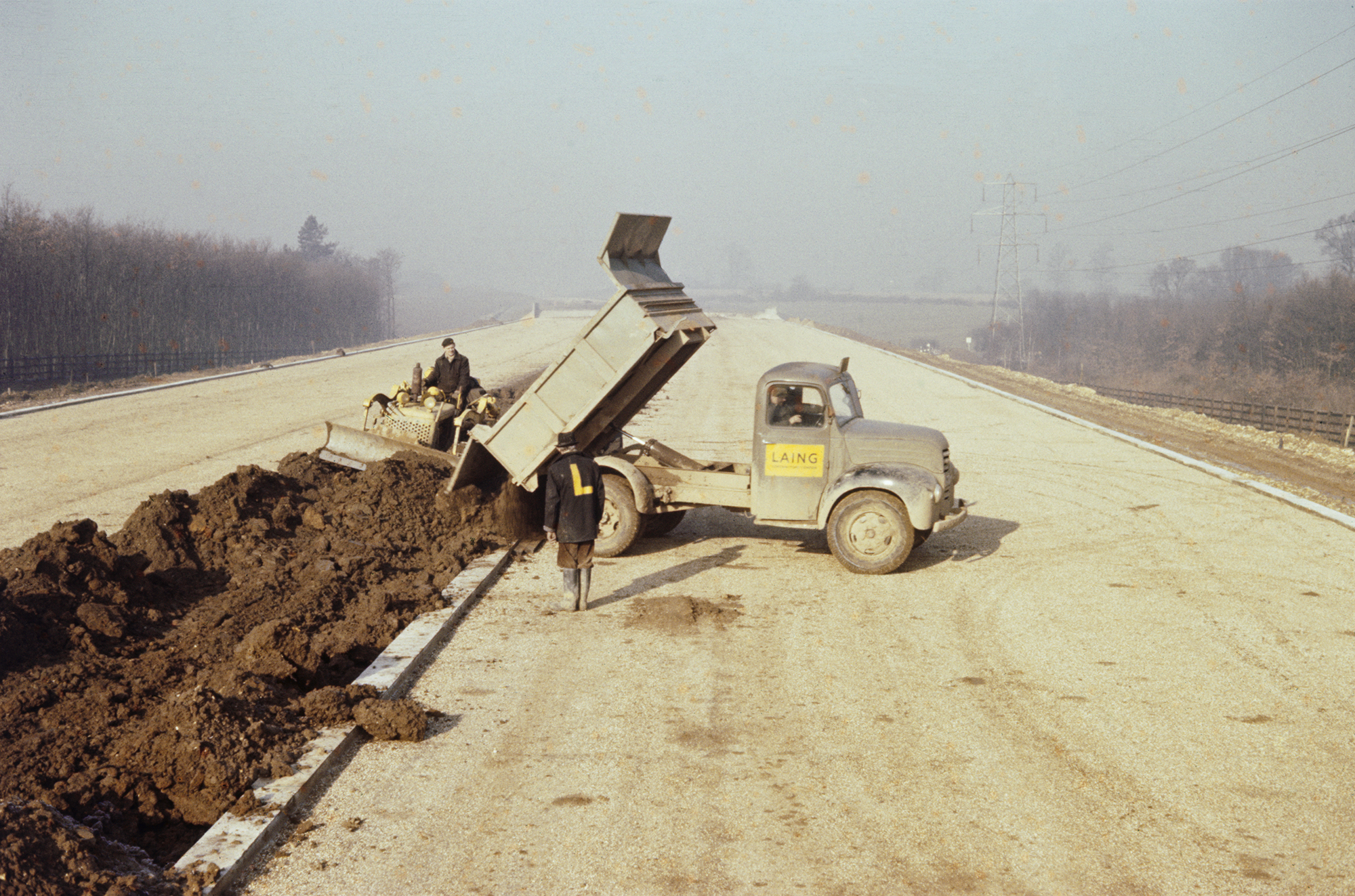 Earth being tipped into the central reservation of the M1 motorway by dumper truck.