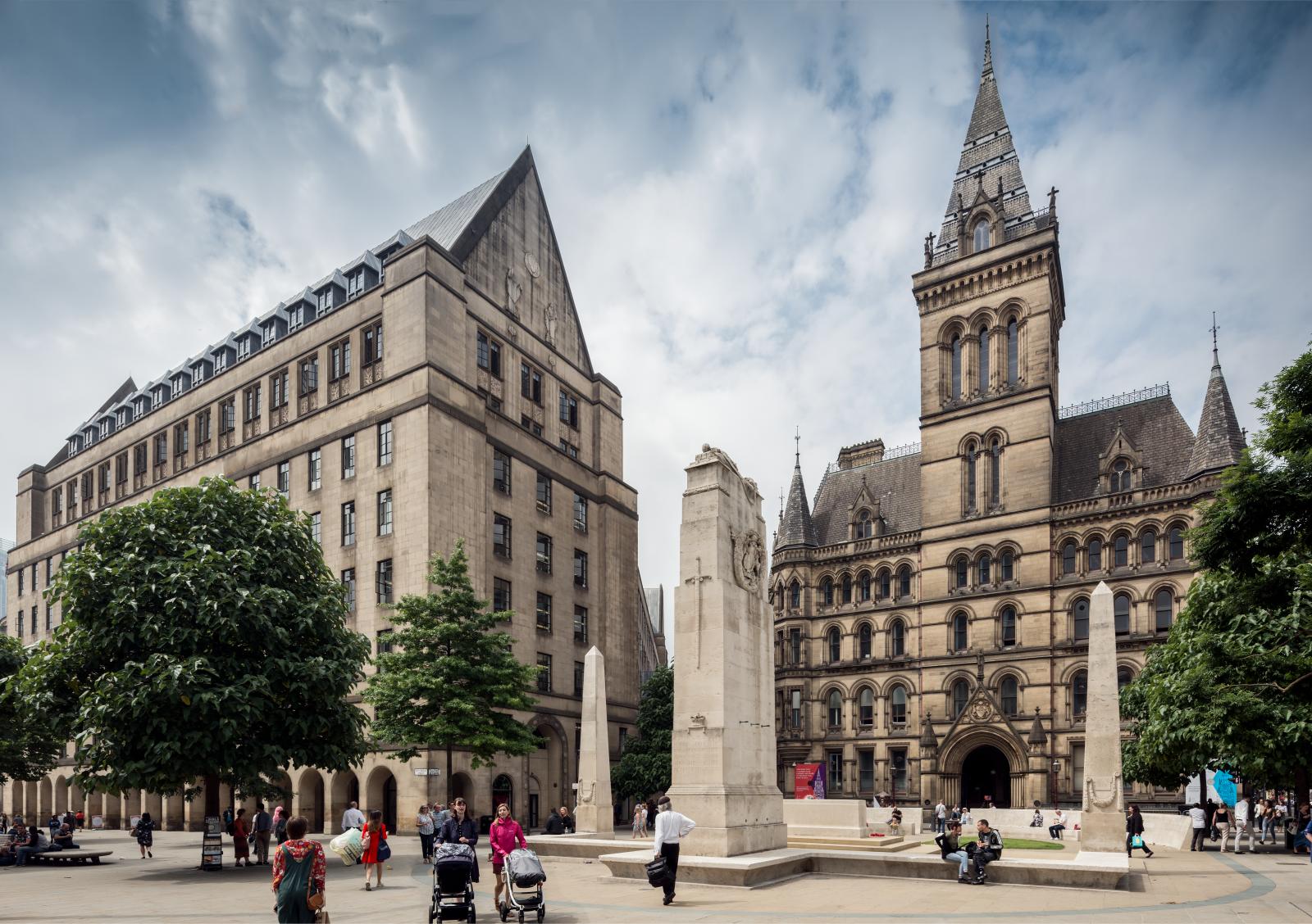 Manchester Town Hall and extension with cenotaph and pedestrians in the foreground.