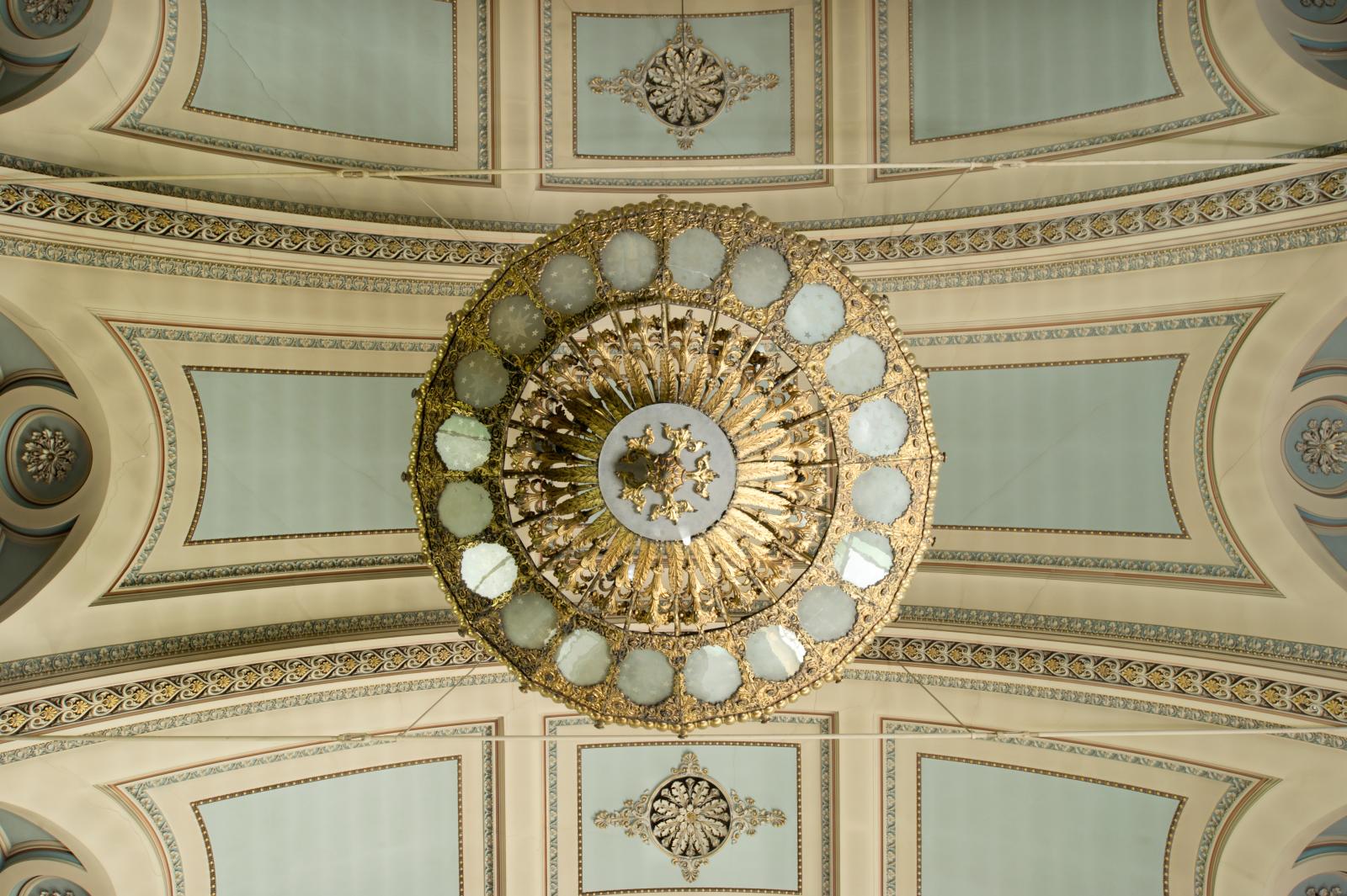 a church ceiling with a round light fitting in the centre