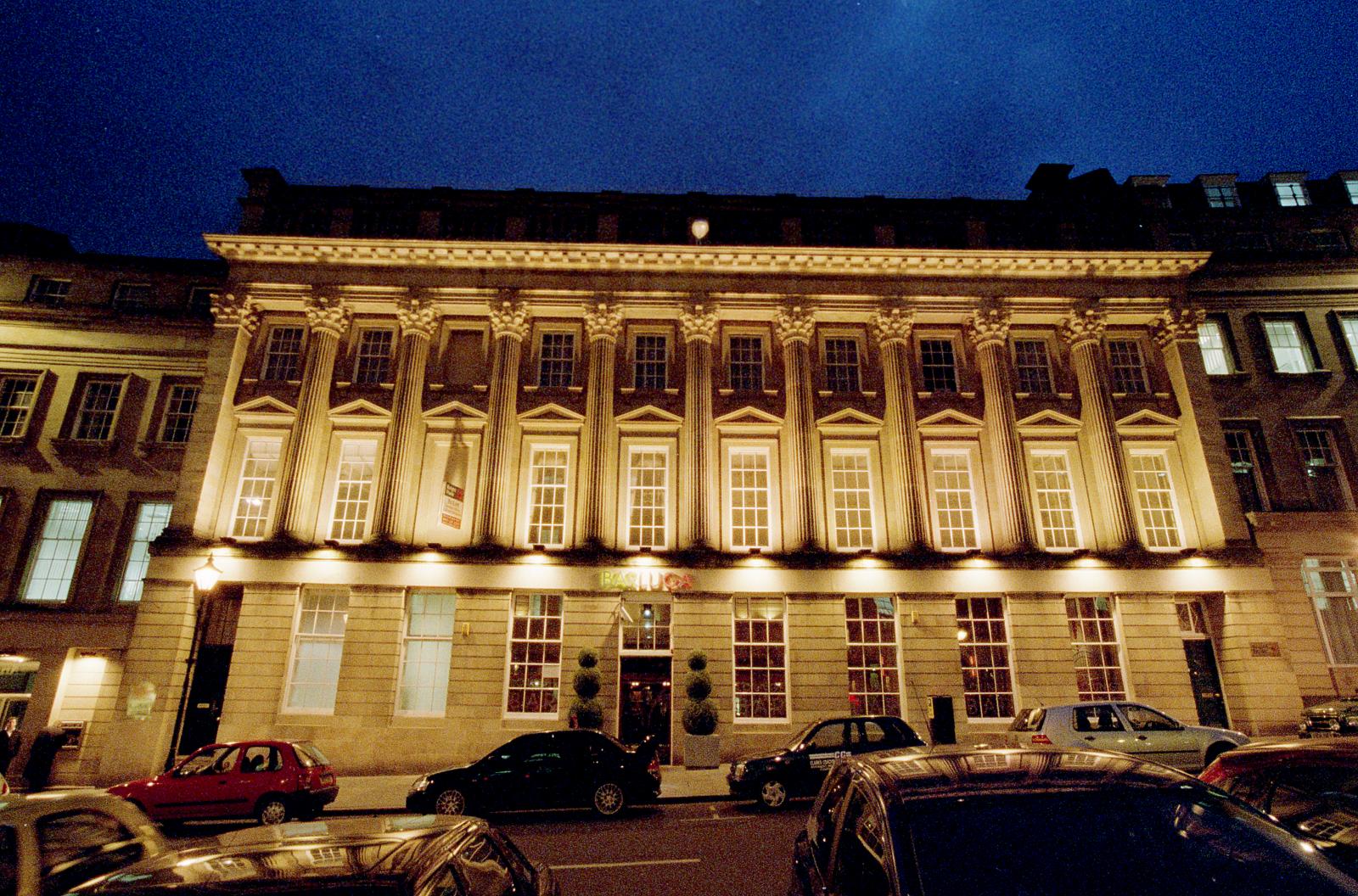 Night time view of Georgian building featuring Giant Corinthian Order which contains sash windows in architraves