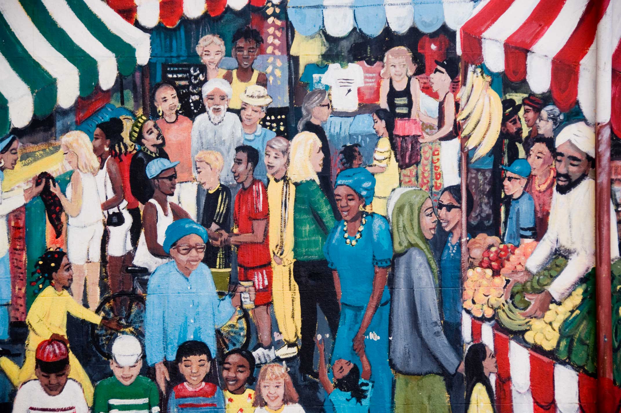 A mural showing a multi-cultural market scene.