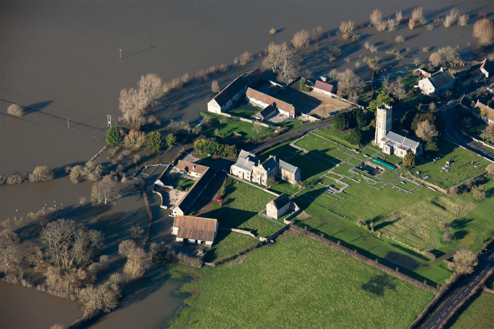 An aerial view of the impact of flooding at a Medieval Abbey.