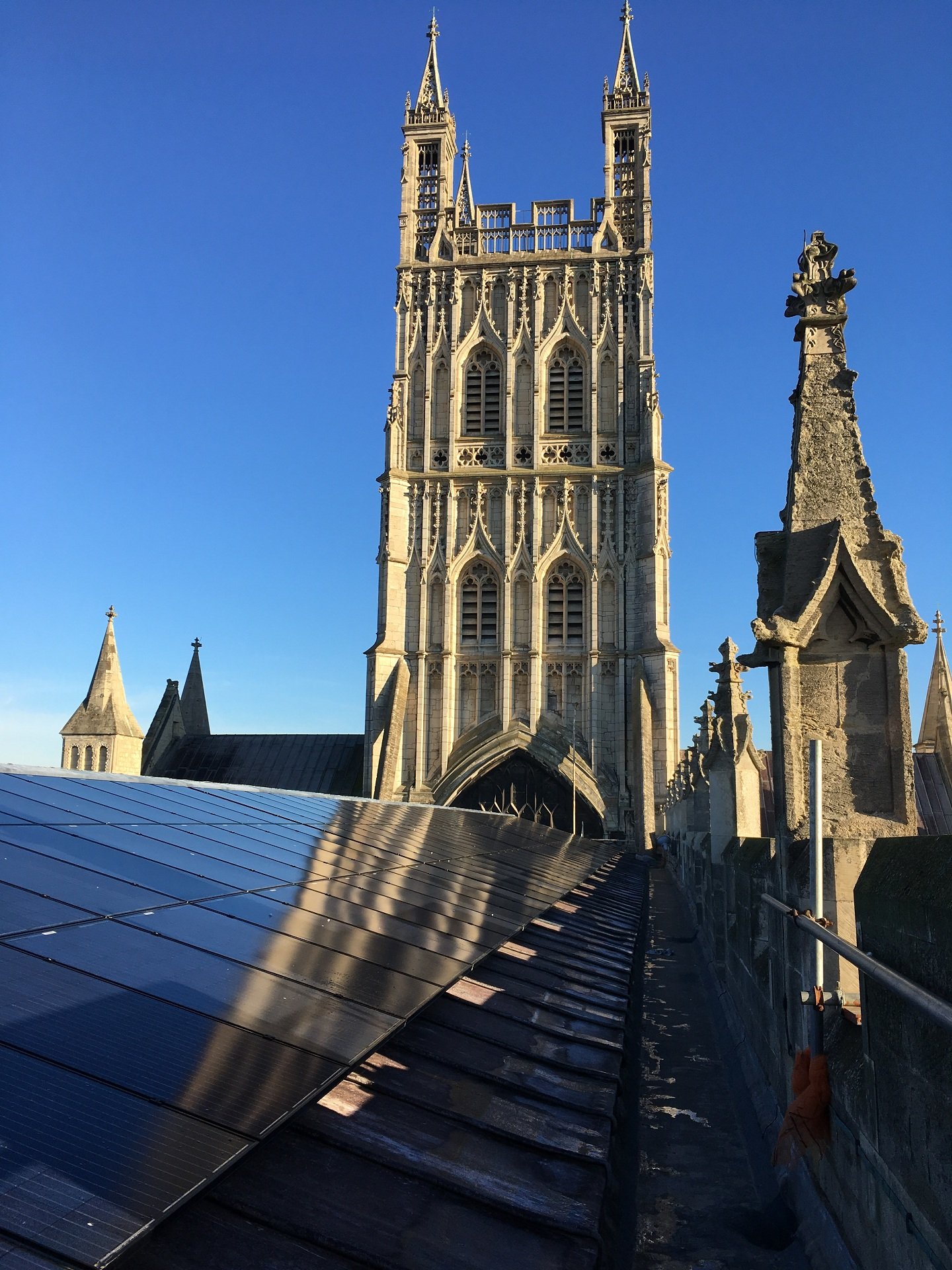 A view along the roof of the nave of Gloucester Cathedral showing all the solar panels.