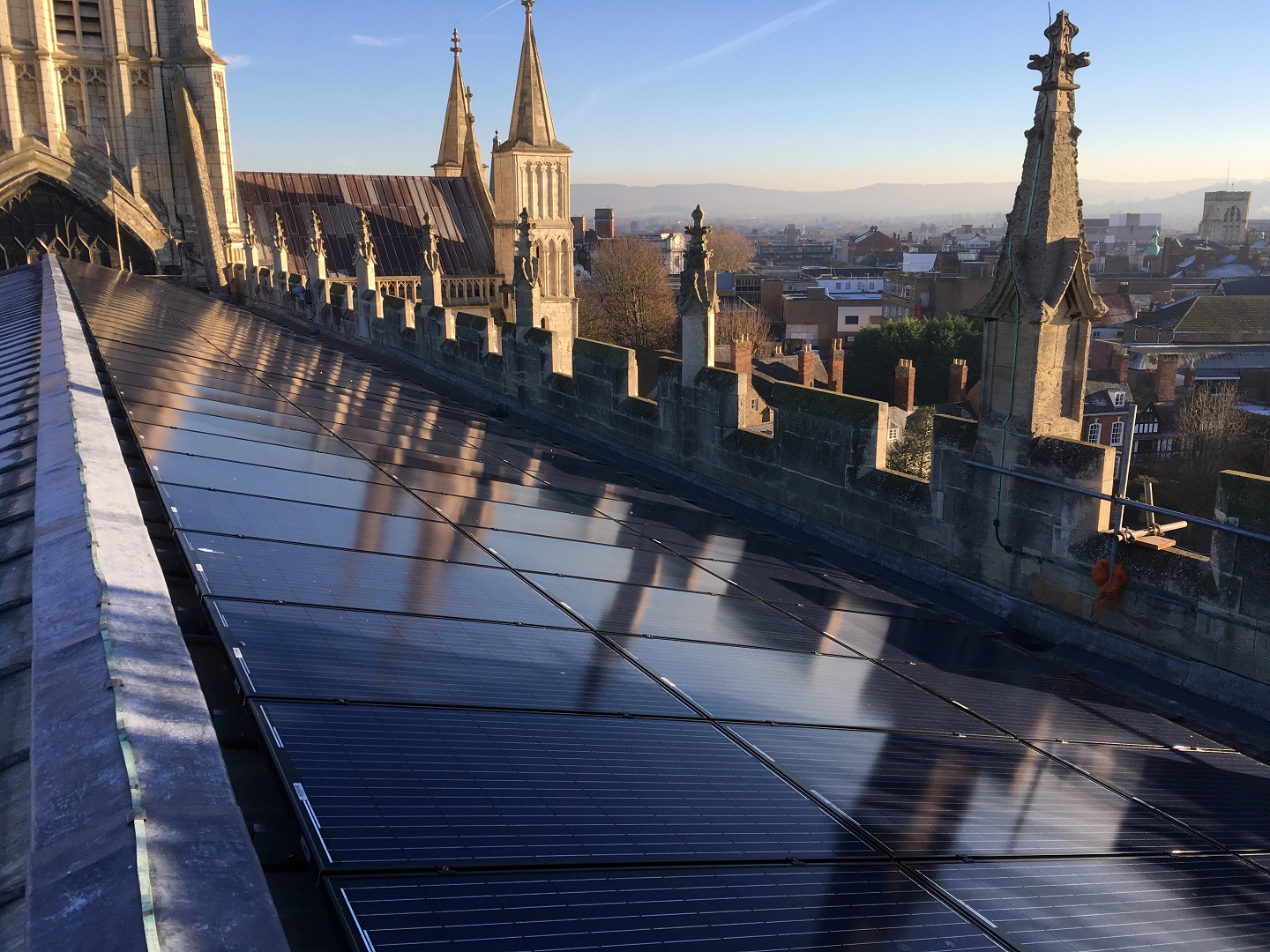 A close up view along the roof of the nave of Gloucester Cathedral showing the solar panels.