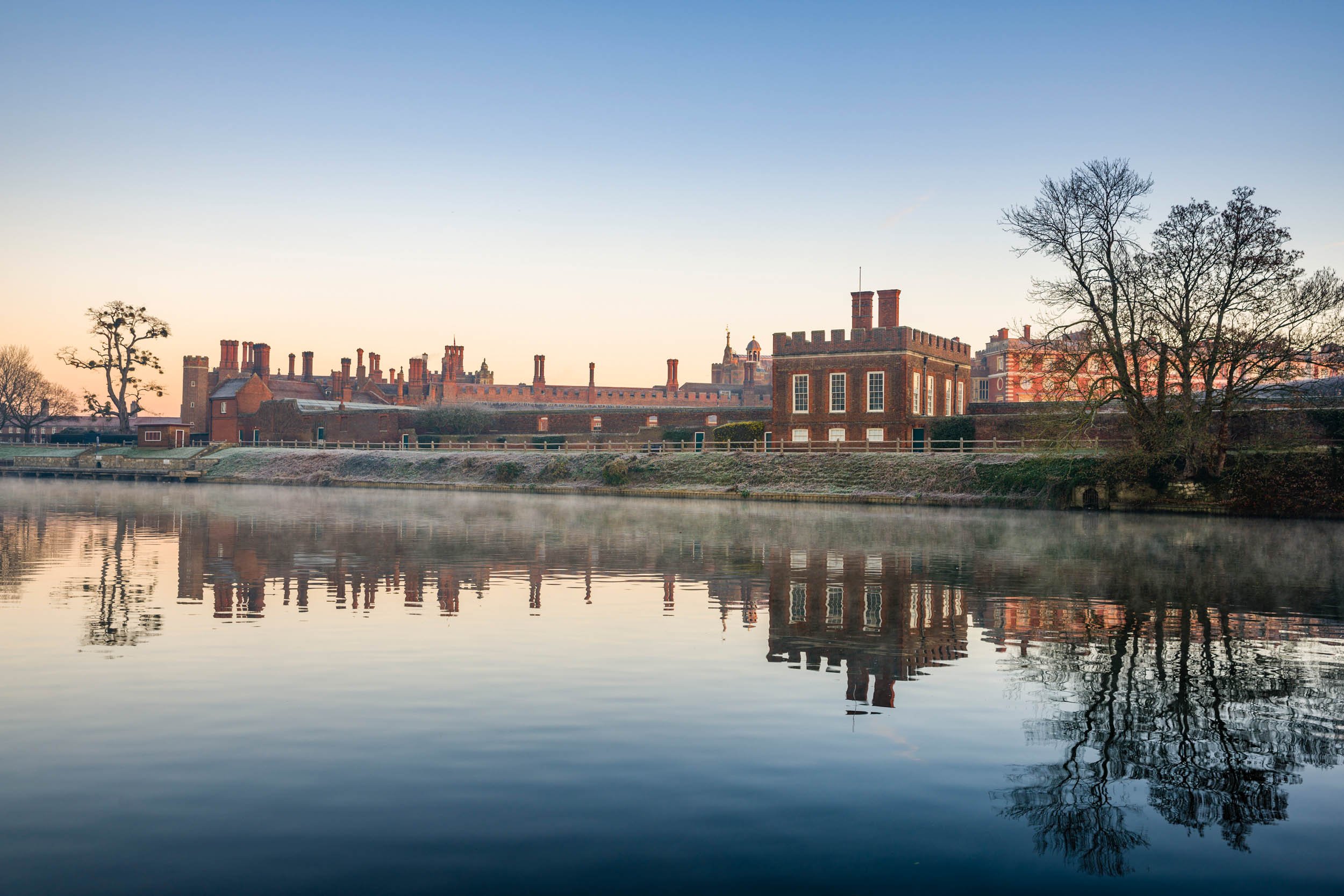 The Banqueting House and Hampton Court Palace with mist rising from the River Thames on a cold morning in the foreground.