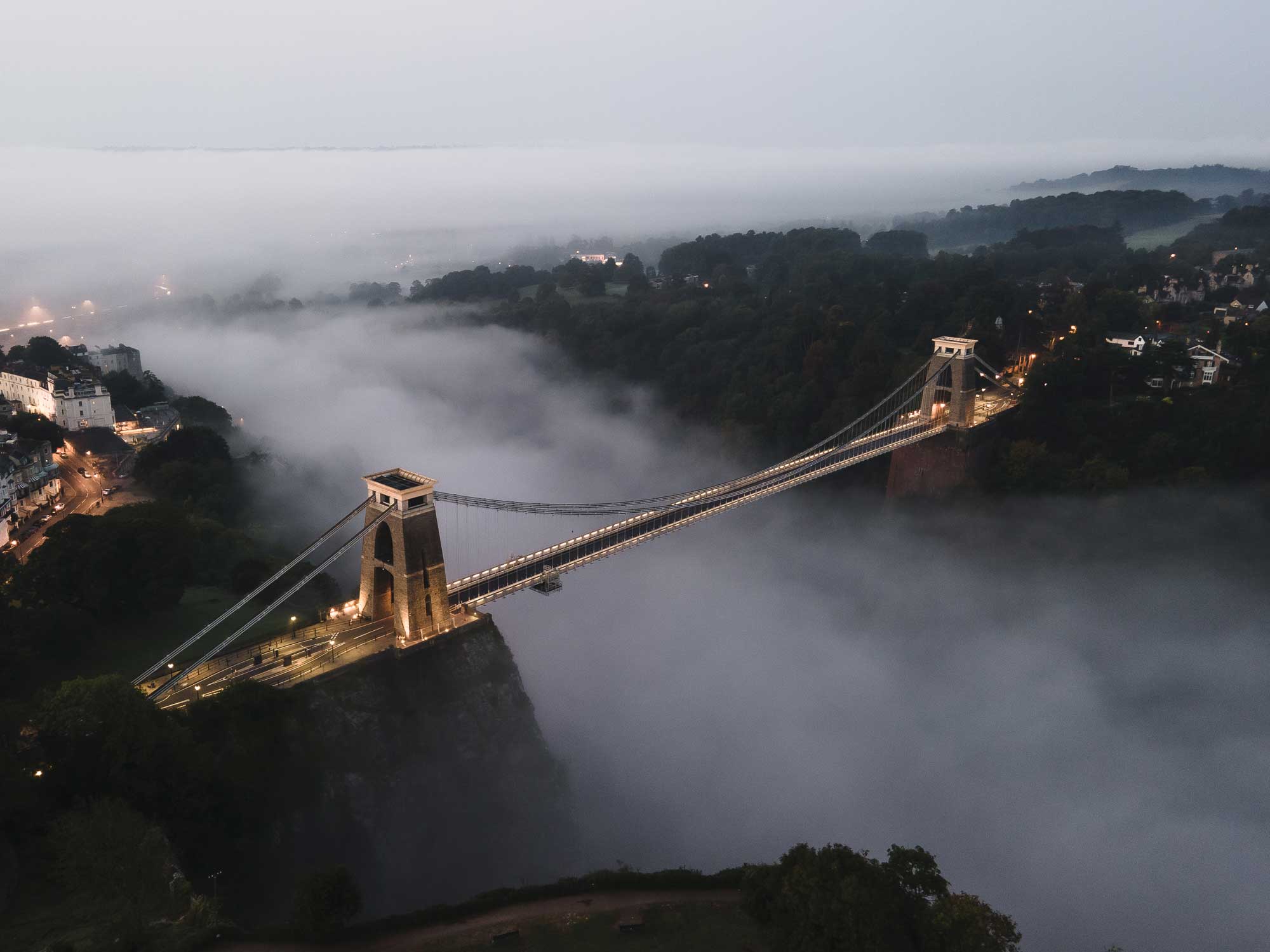 Aerial view of Clifton Suspension Bridge with mist below it