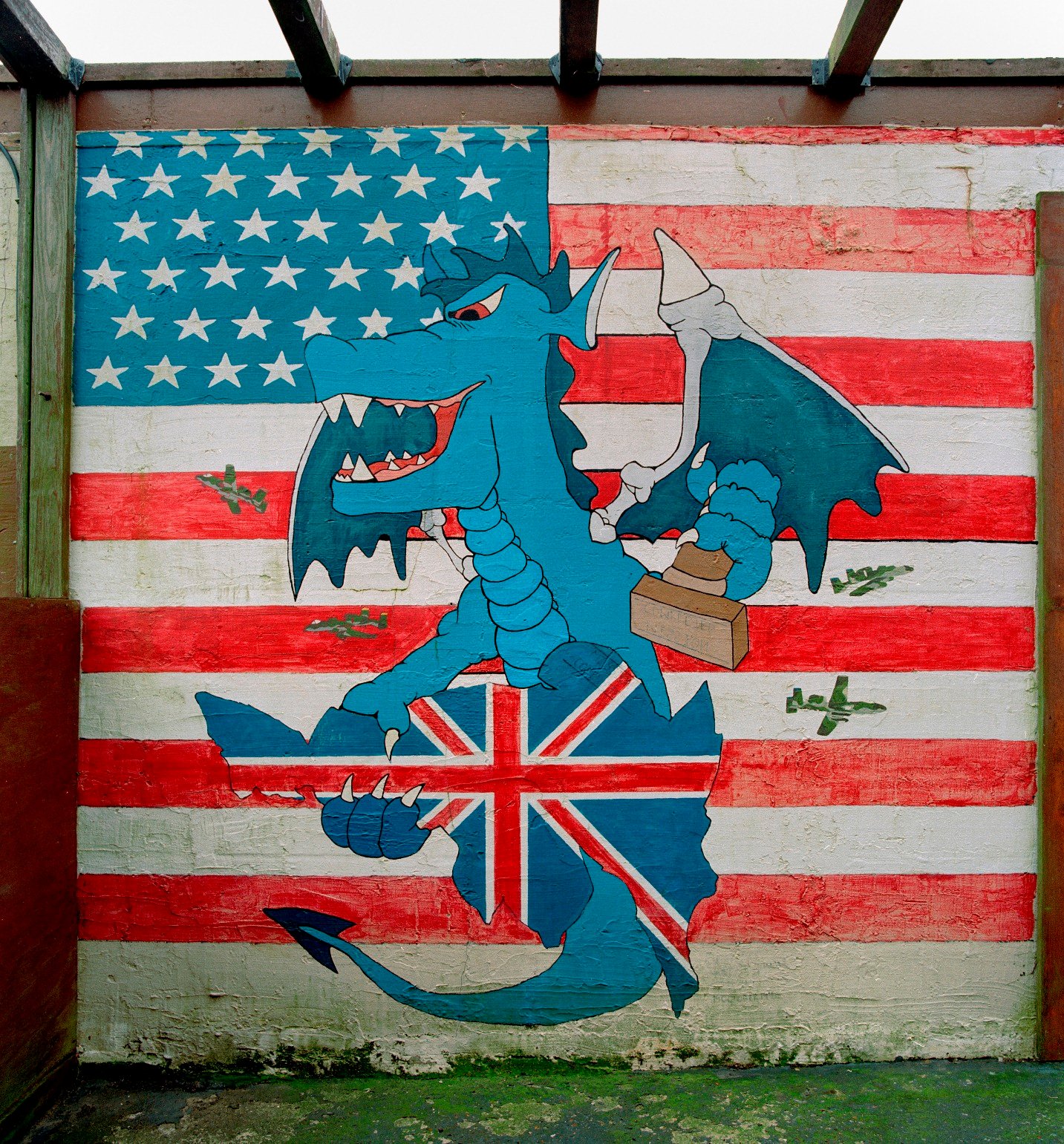 RAF Bentwaters, Suffolk, a mural showing a dragon clasping the United Kingdom with A-10 Thunderbolt aircraft buzzing around against the background of the stars and stripes.
