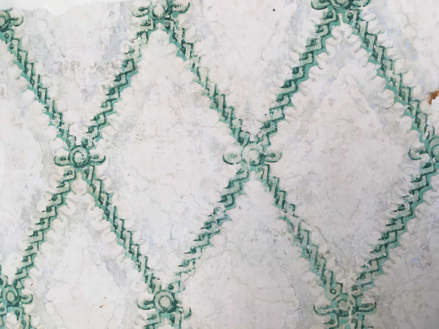 A historic wallpaper featuring a floral diamond pattern. The green pigment contains arsenic.