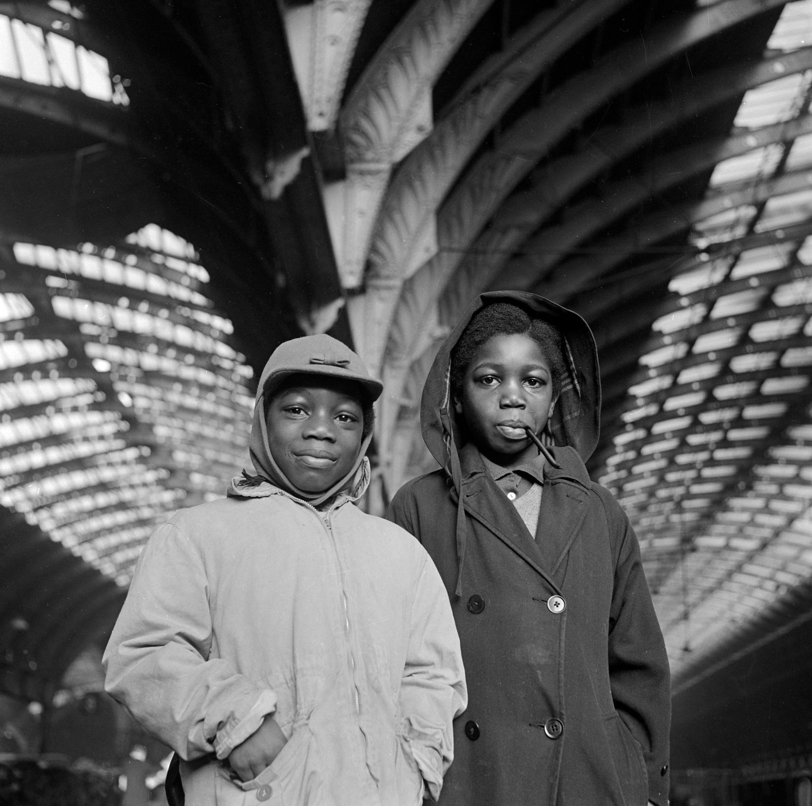 Two boys at Paddington Station. Black and white photo taken in 1960s.