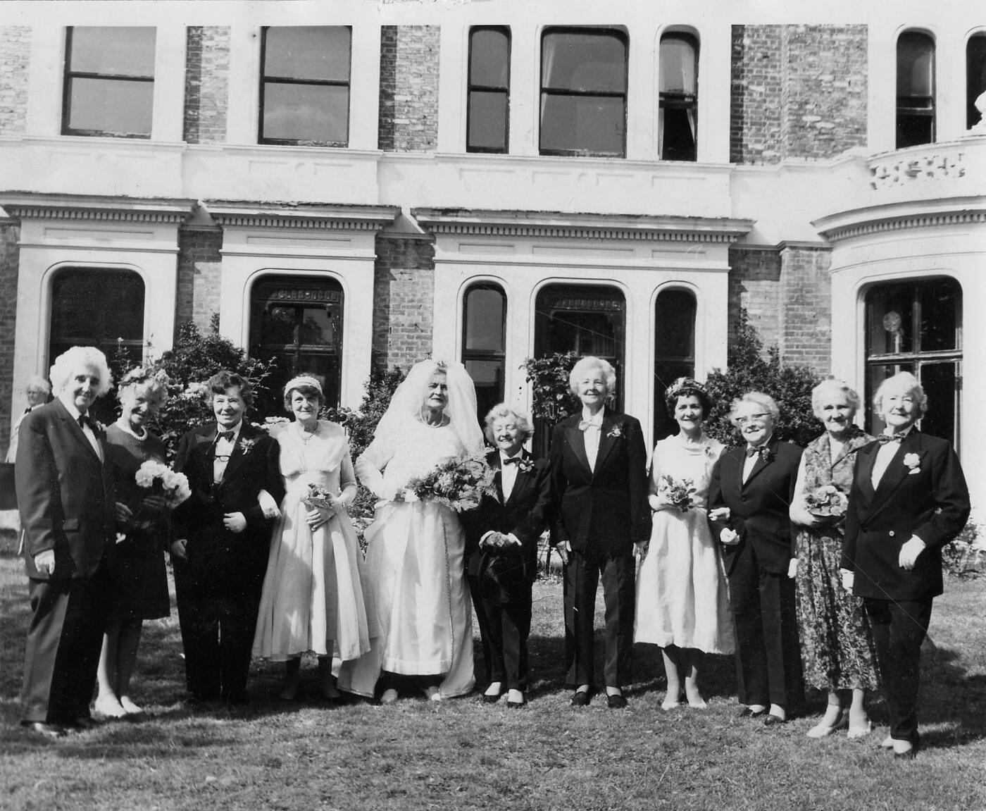 A wedding group photographed on the lawn at the Streatham Derby and Joan Club.