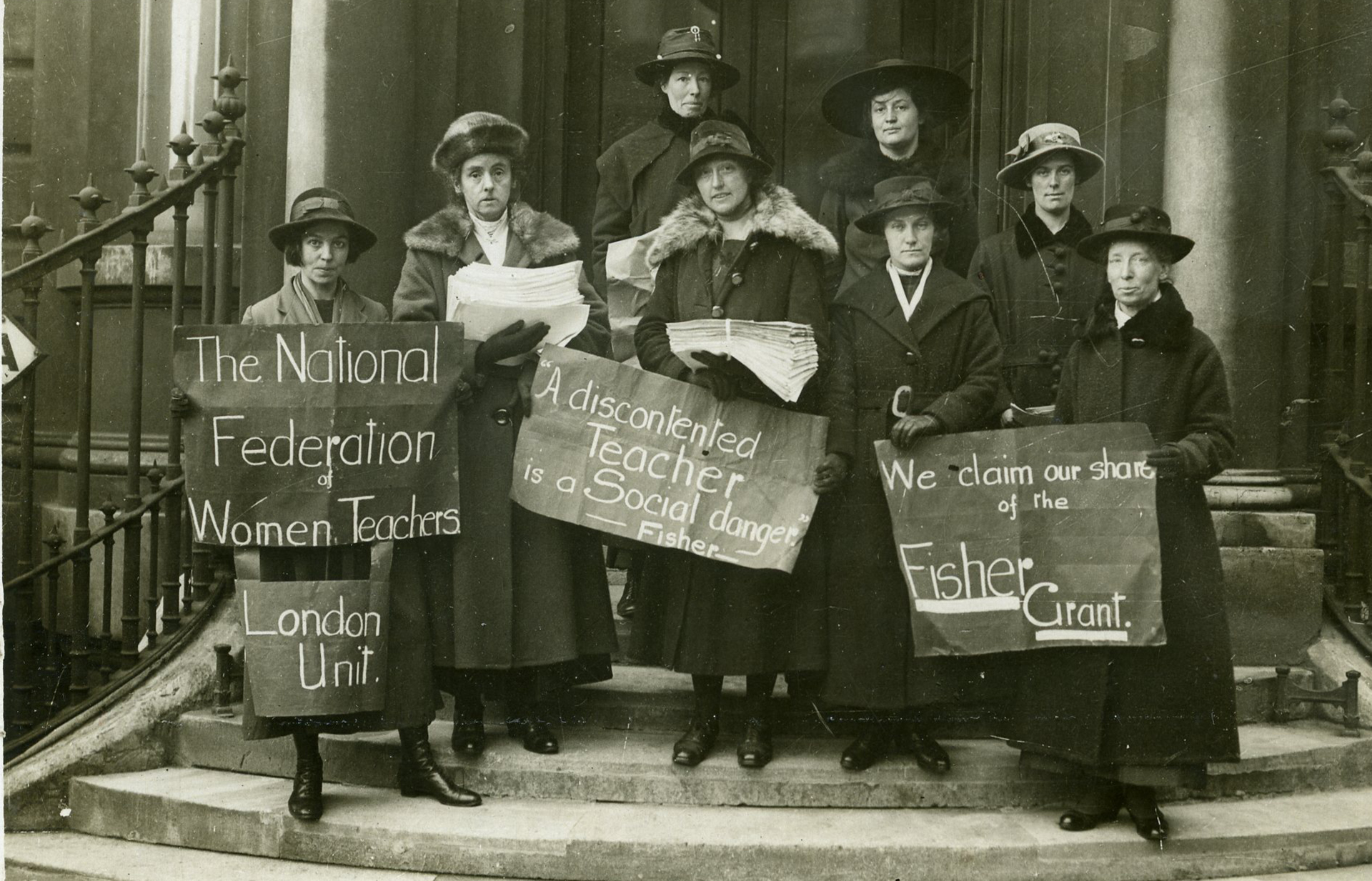 Postcard of members of the NUWT London Unit standing on steps demonstrating for equal pay