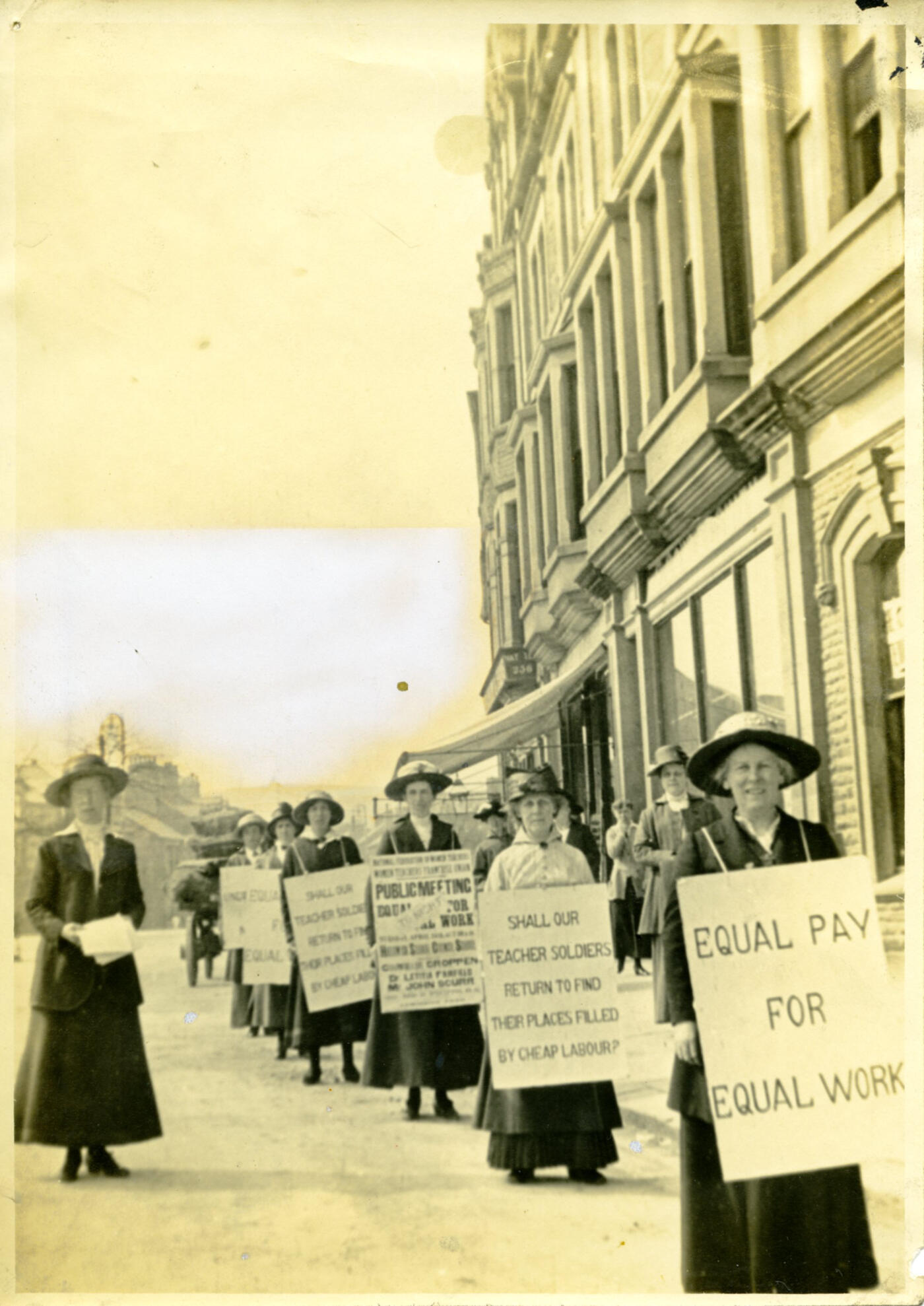 Photograph of women holding placards at NUWT equal pay demonstration