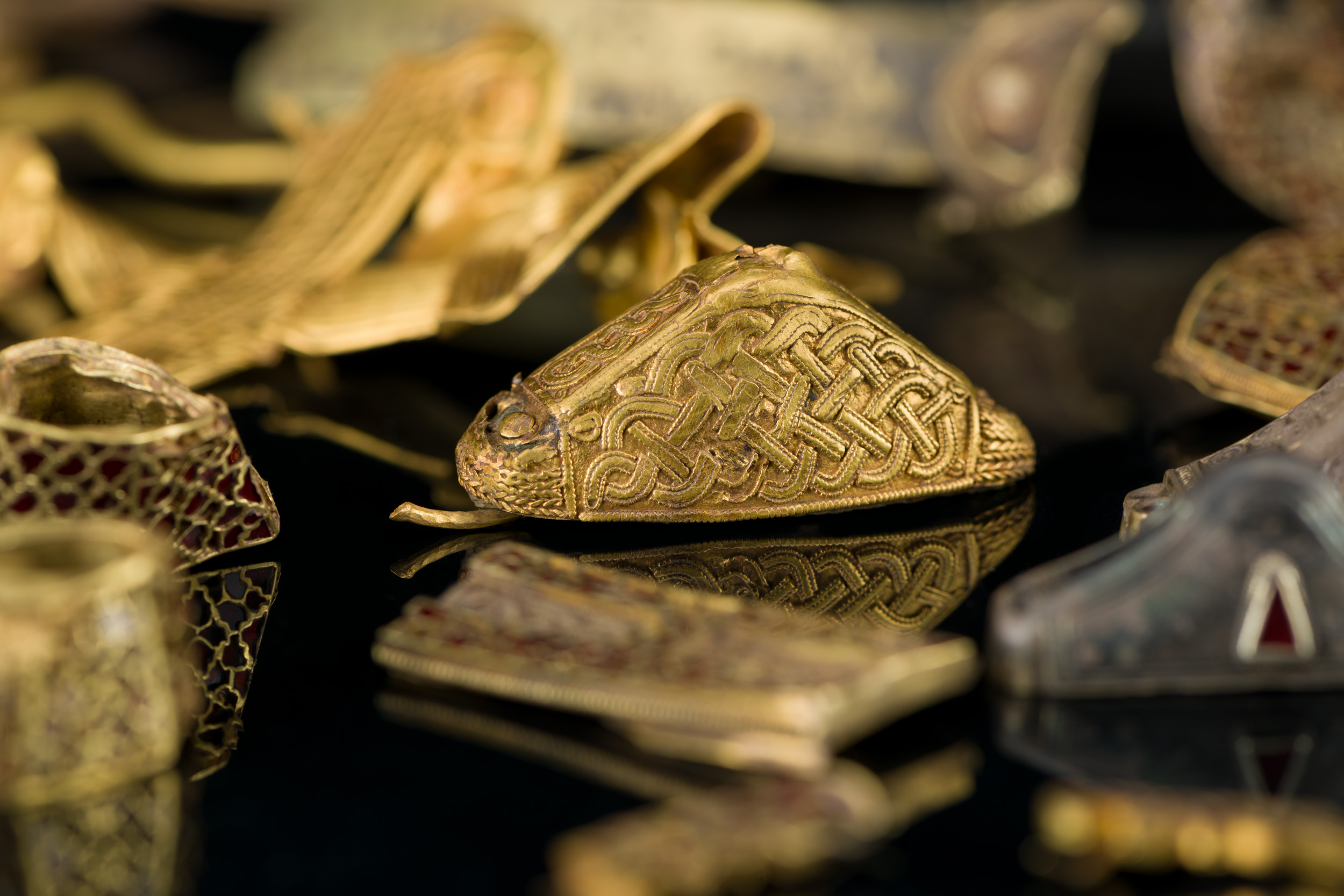 Detail of a group of decorated gold objects.