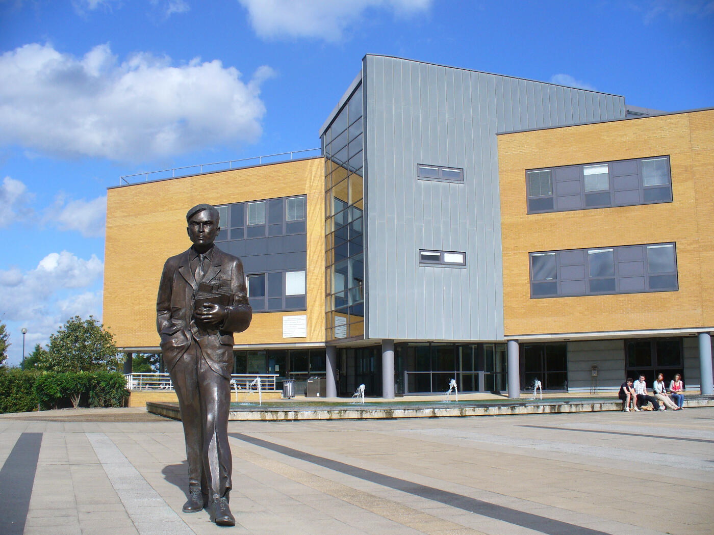 Statue of Alan Turing stanidng in front of building