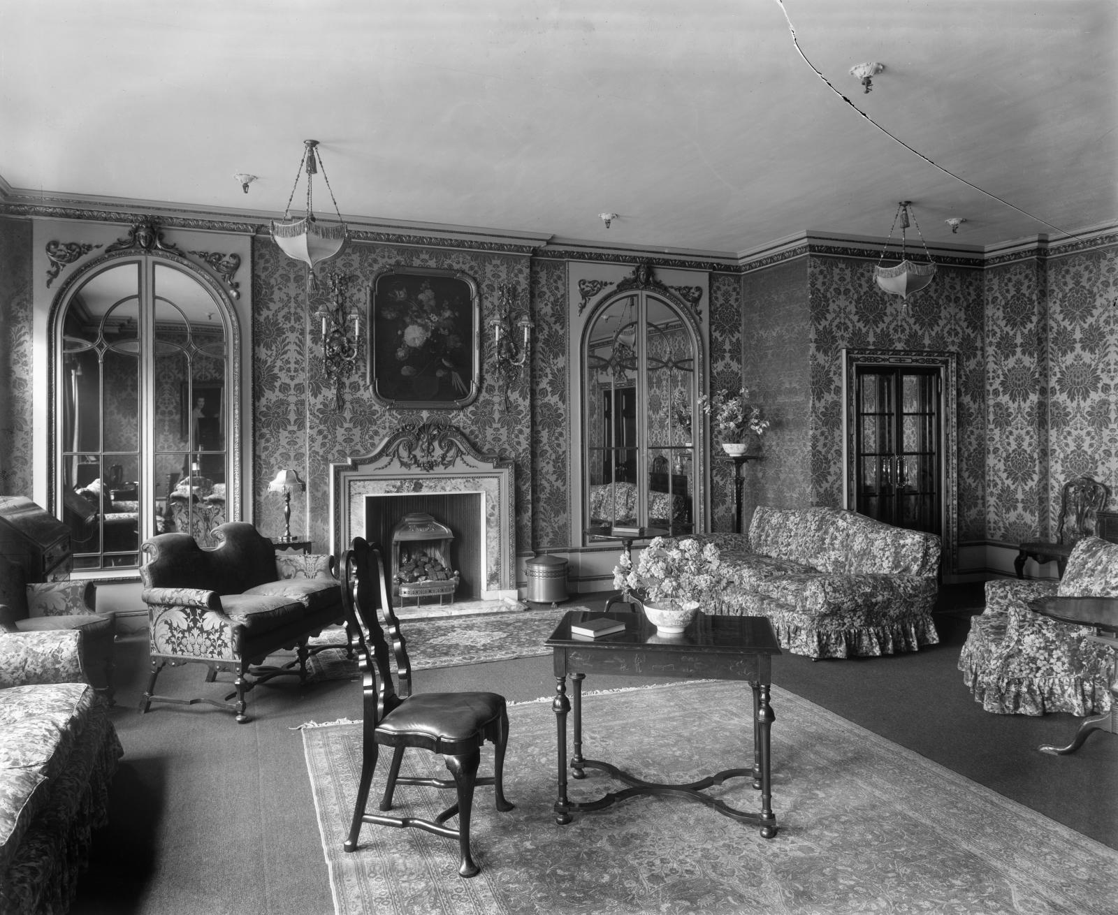 Elaborately decorated room with sofas, armchairs, and table