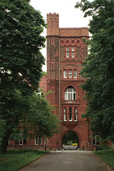 Girton College’s neo-Tudor Gatehouse Tower over the carriage entrance was built 1886-1887 to designs of  Alfred Waterhouse and is listed Grade II* along with the rest of the college. 
© Tony Wilding (2005) Source Historic England.NMR.