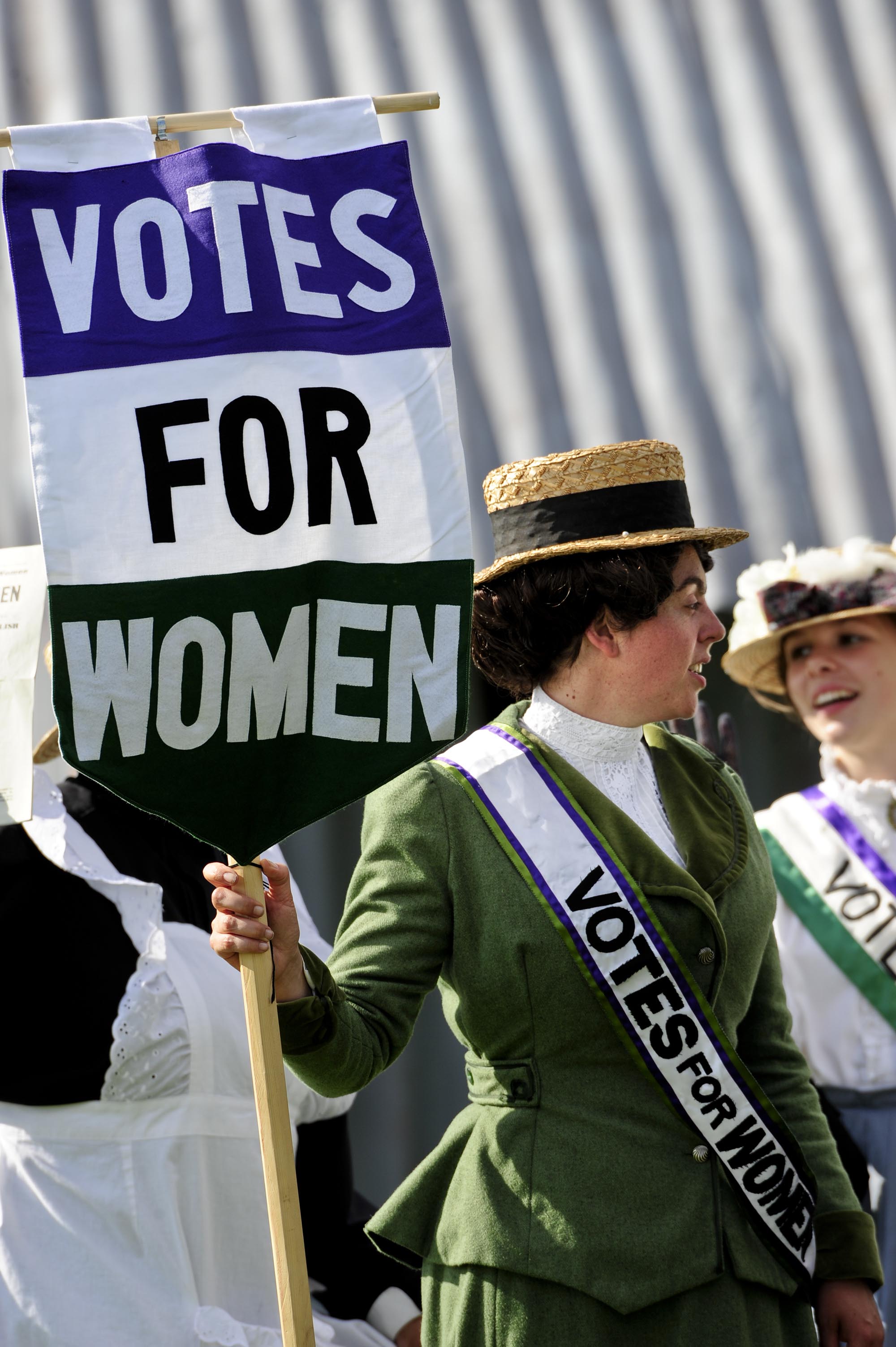 Suffragette with ‘Votes for Women’ banner