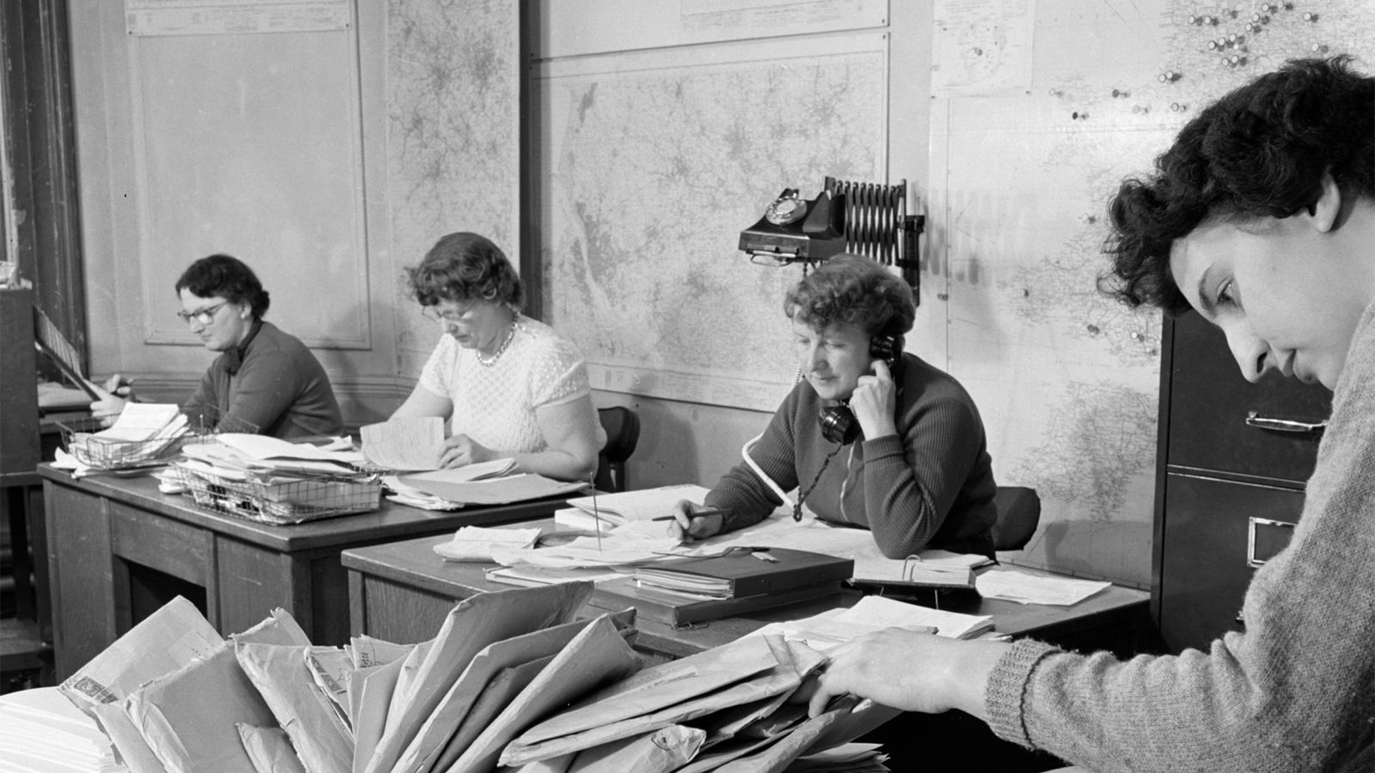 Black and white photo of women working in an office, 1956.