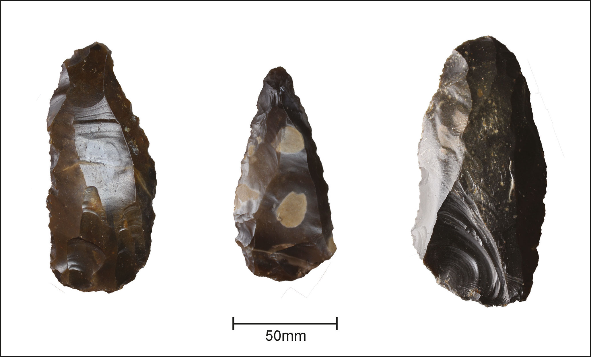A photograph showing three views of stone tools.