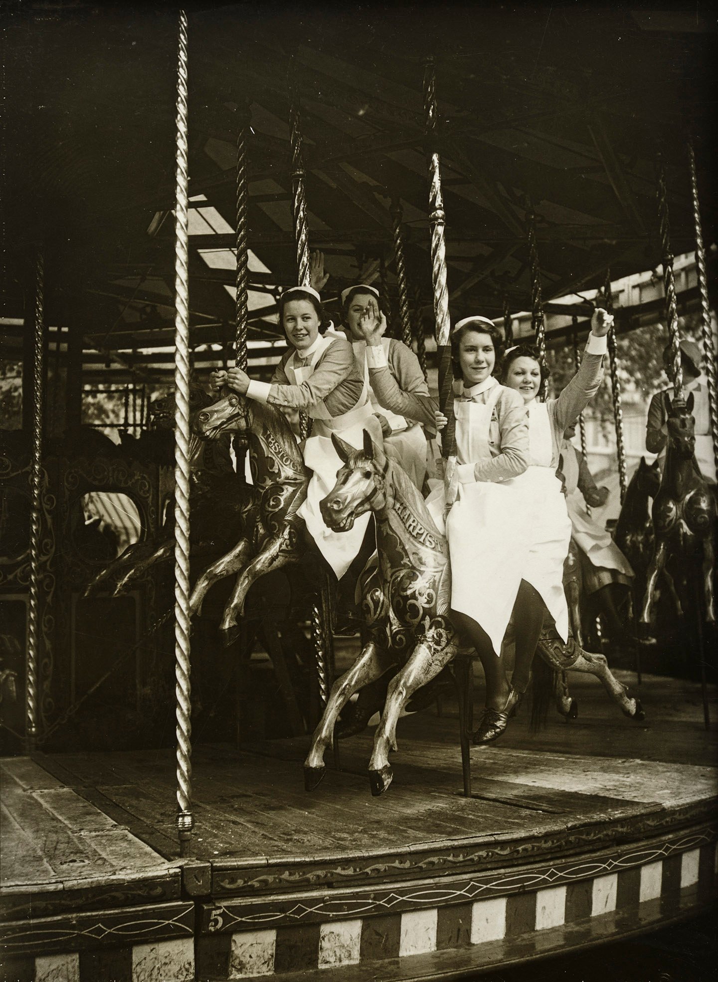 Nurses waving from a merry-go-round