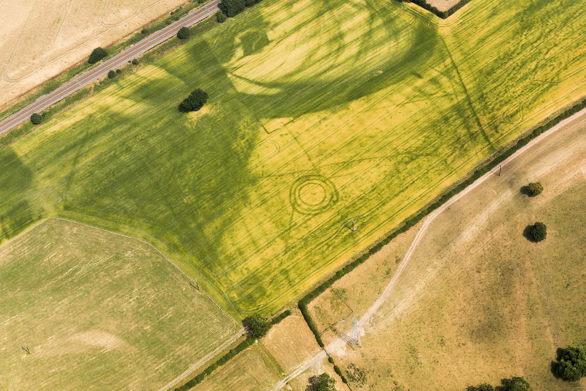 Aerial view of Bronze Age burial mound and prehistoric pit alignment