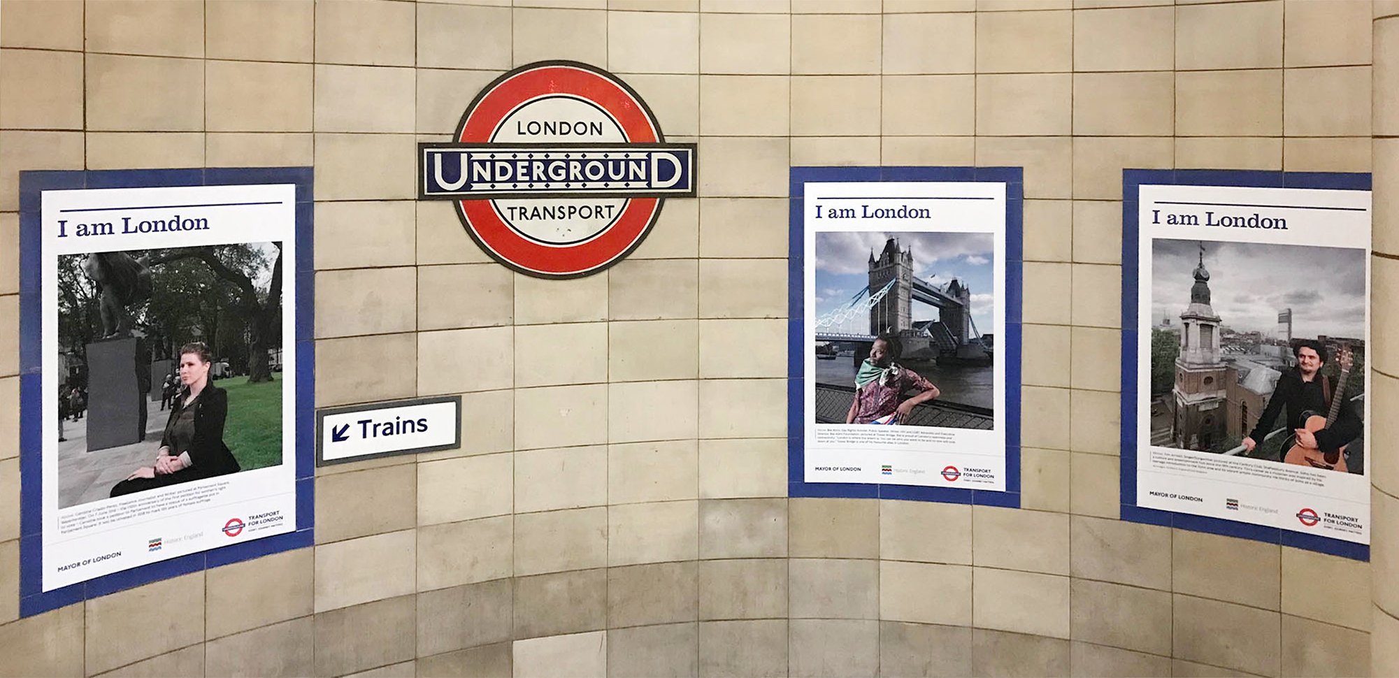 Three portraits from Historic England's I am London series displayed at Algate East Underground Station