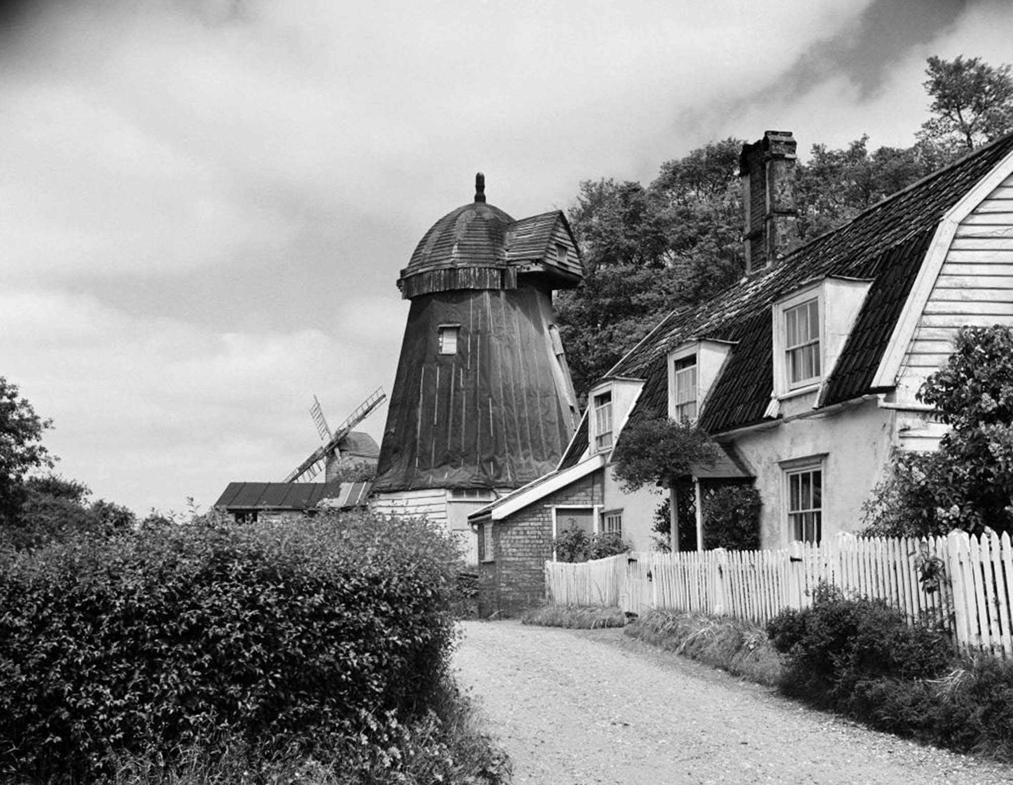 General view from lane showing cap of post mill in background