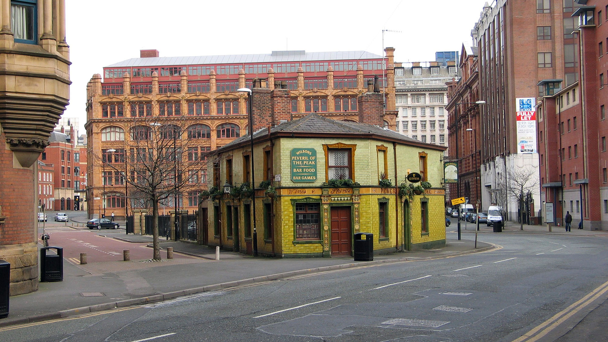 Exterior photo of the green tiled front of the Peveril of the Peak pub.