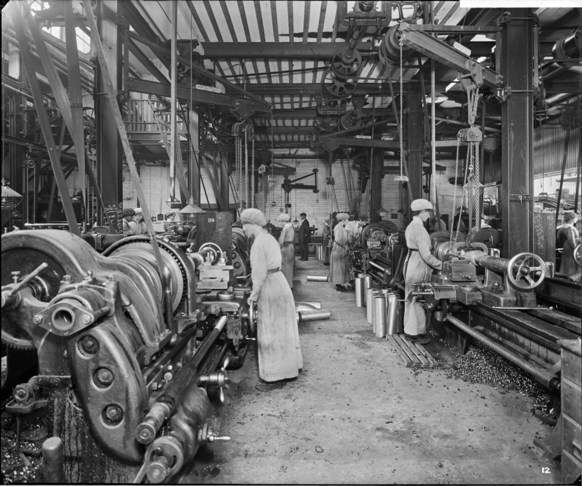 Cunards Shellworks, Liverpool, women workers operate large lathes to carefully finish steel artillery shells