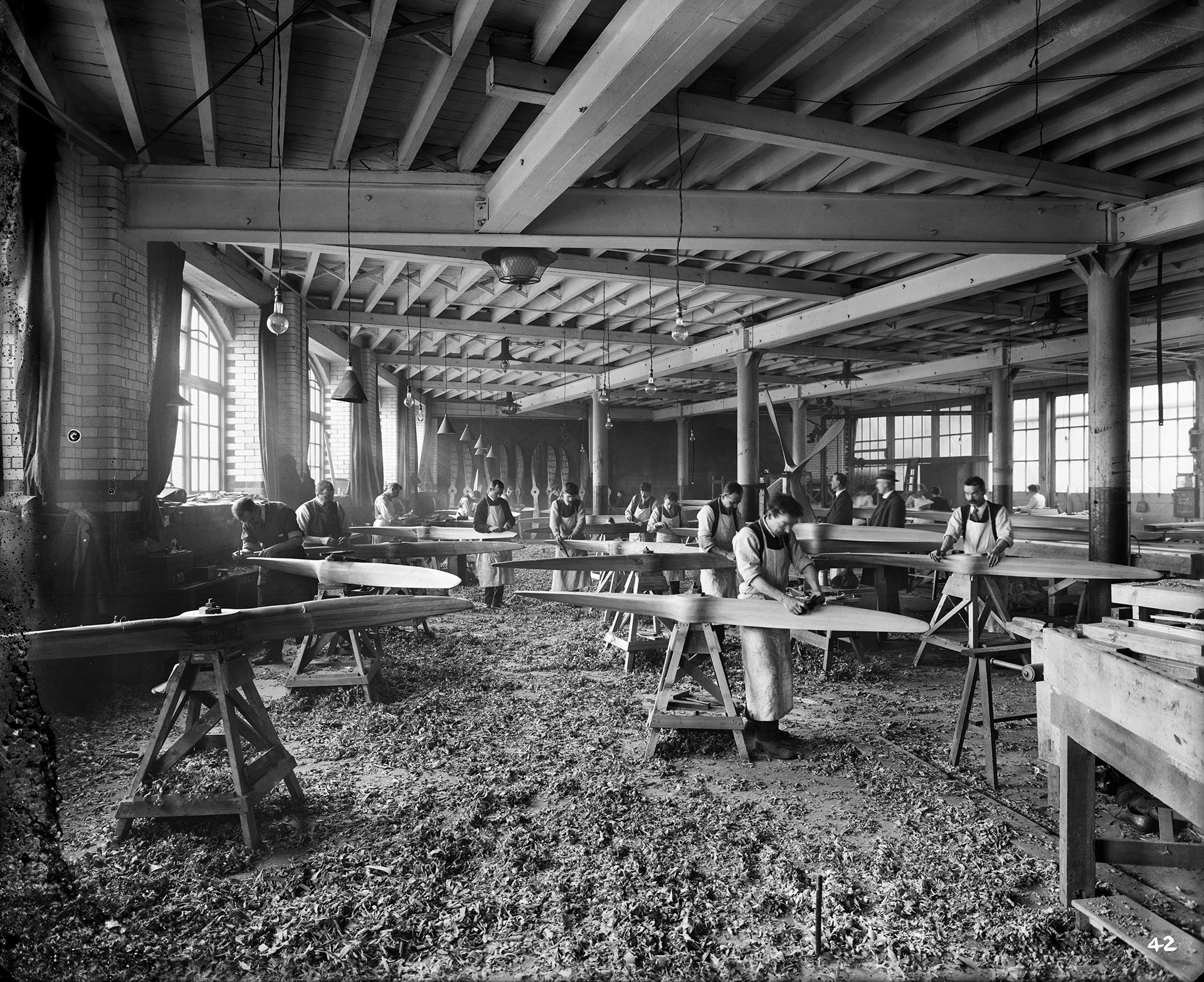 Hampton & Sons Ltd, Lambeth, London, in a wood working shop men carefully shape wooden aircraft propellers