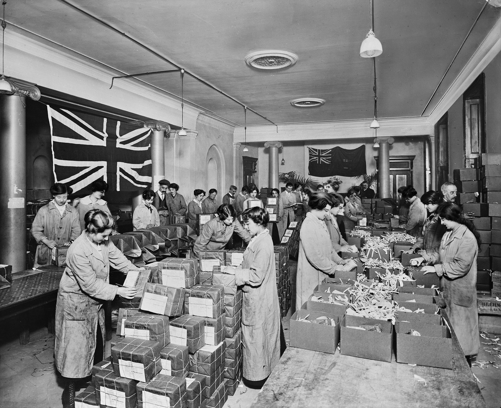 16 Regent Street, London, in a crowded room volunteers at the Australian Red Cross building pack parcels for prisoners of war