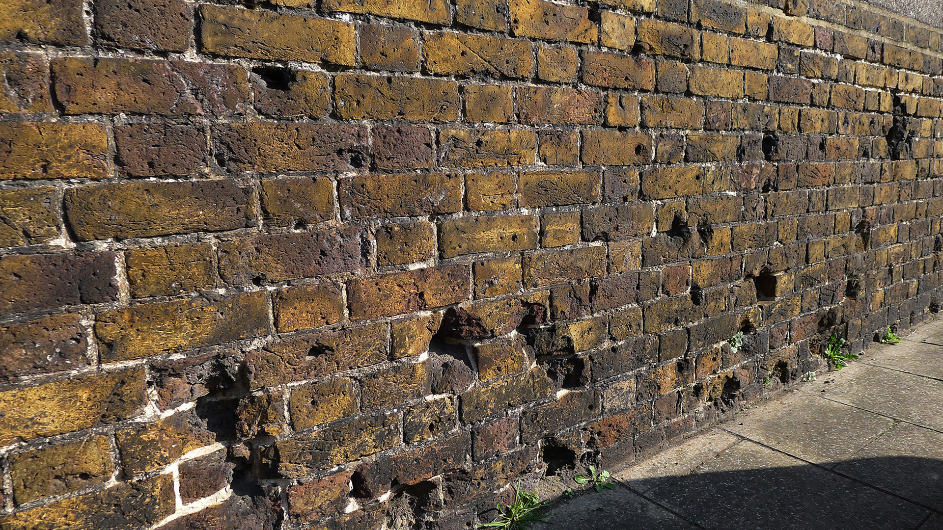 Blue Town, Sheerness, Kent, pockmarks on the brick dockyard wall bear witness to an air raid by German Gotha bombers on 5 June 1917