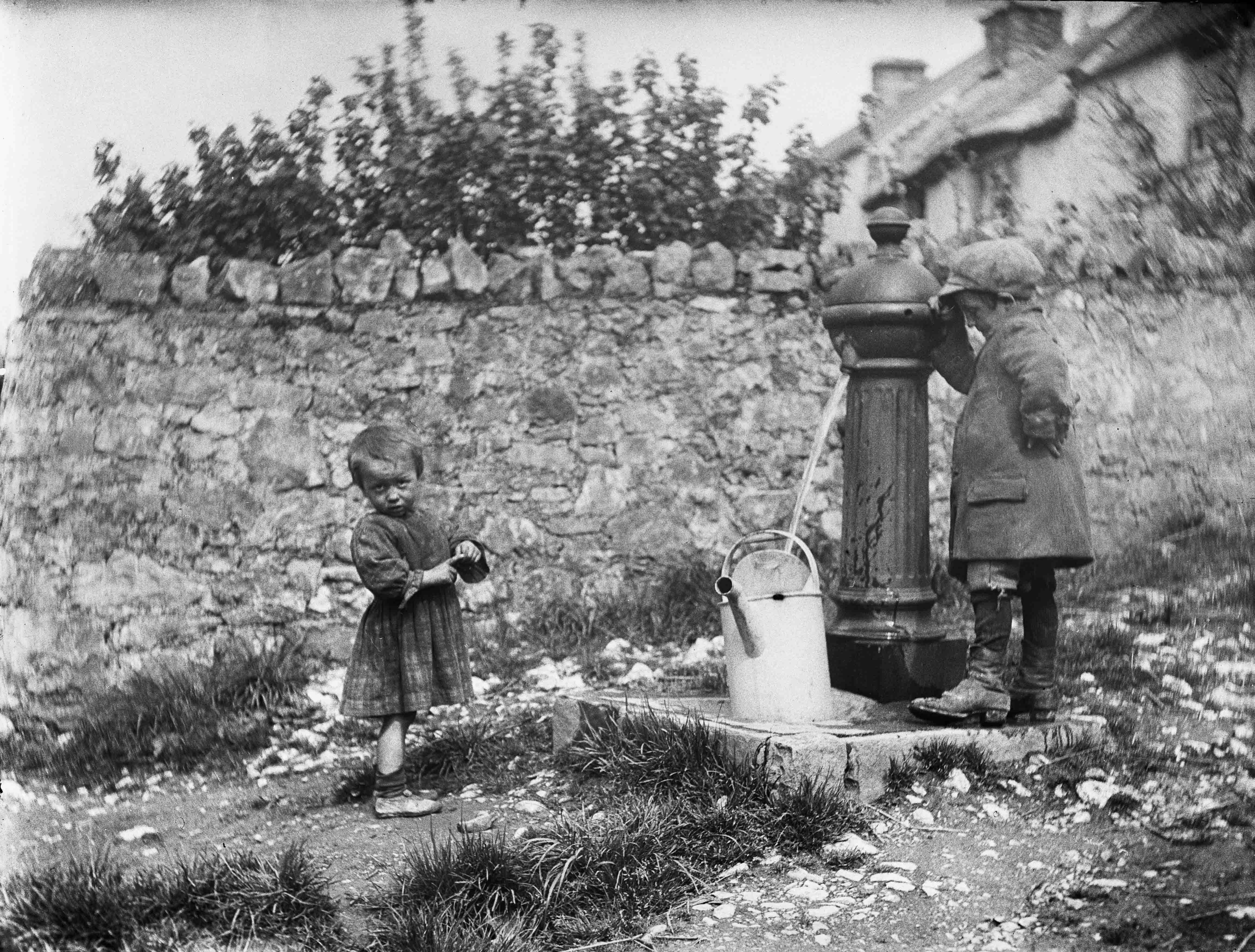 Children collecting water at a pump