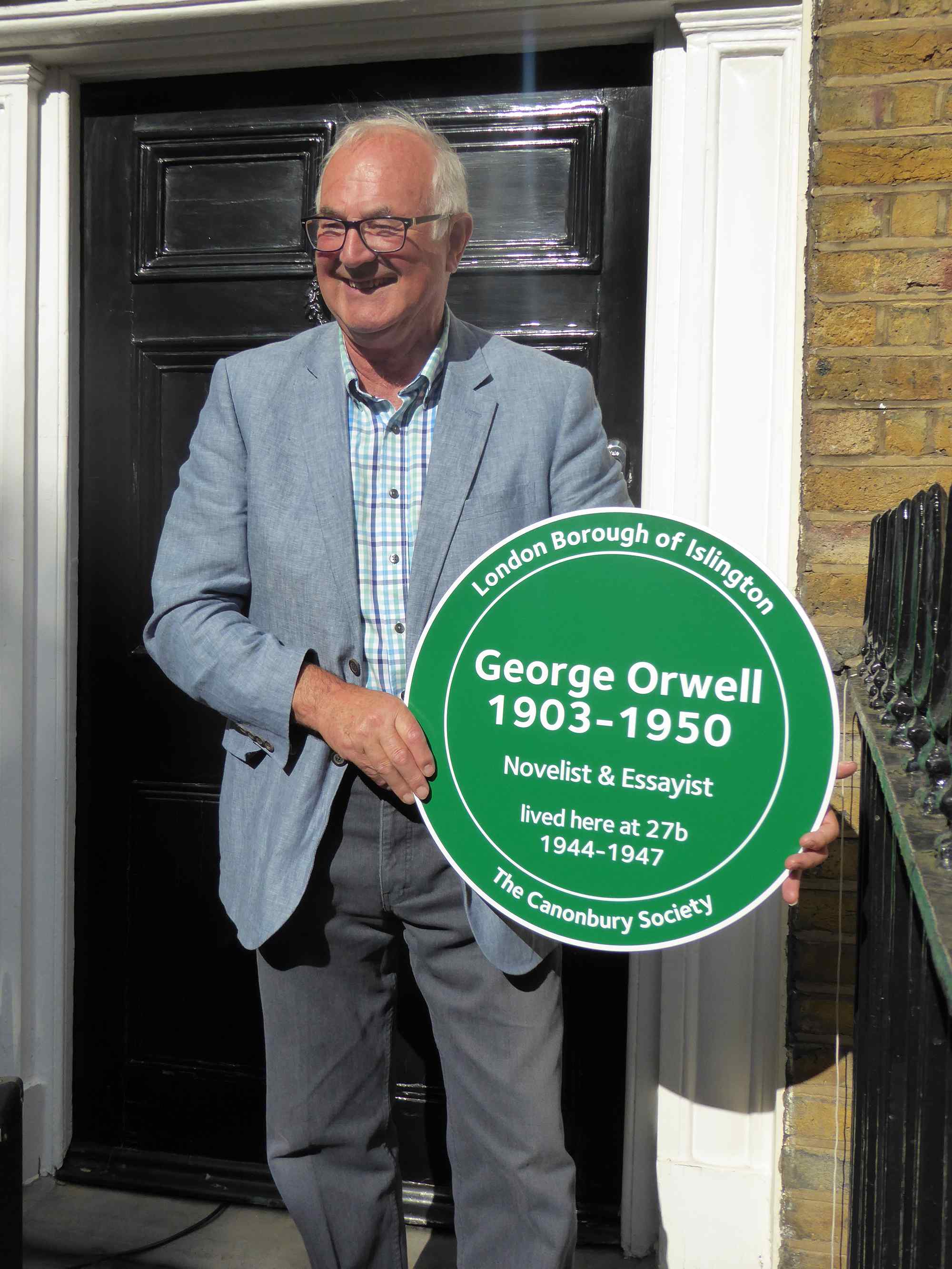Richard Blair is Orwell's son, here holding a plaque erected on the family home in 2016.