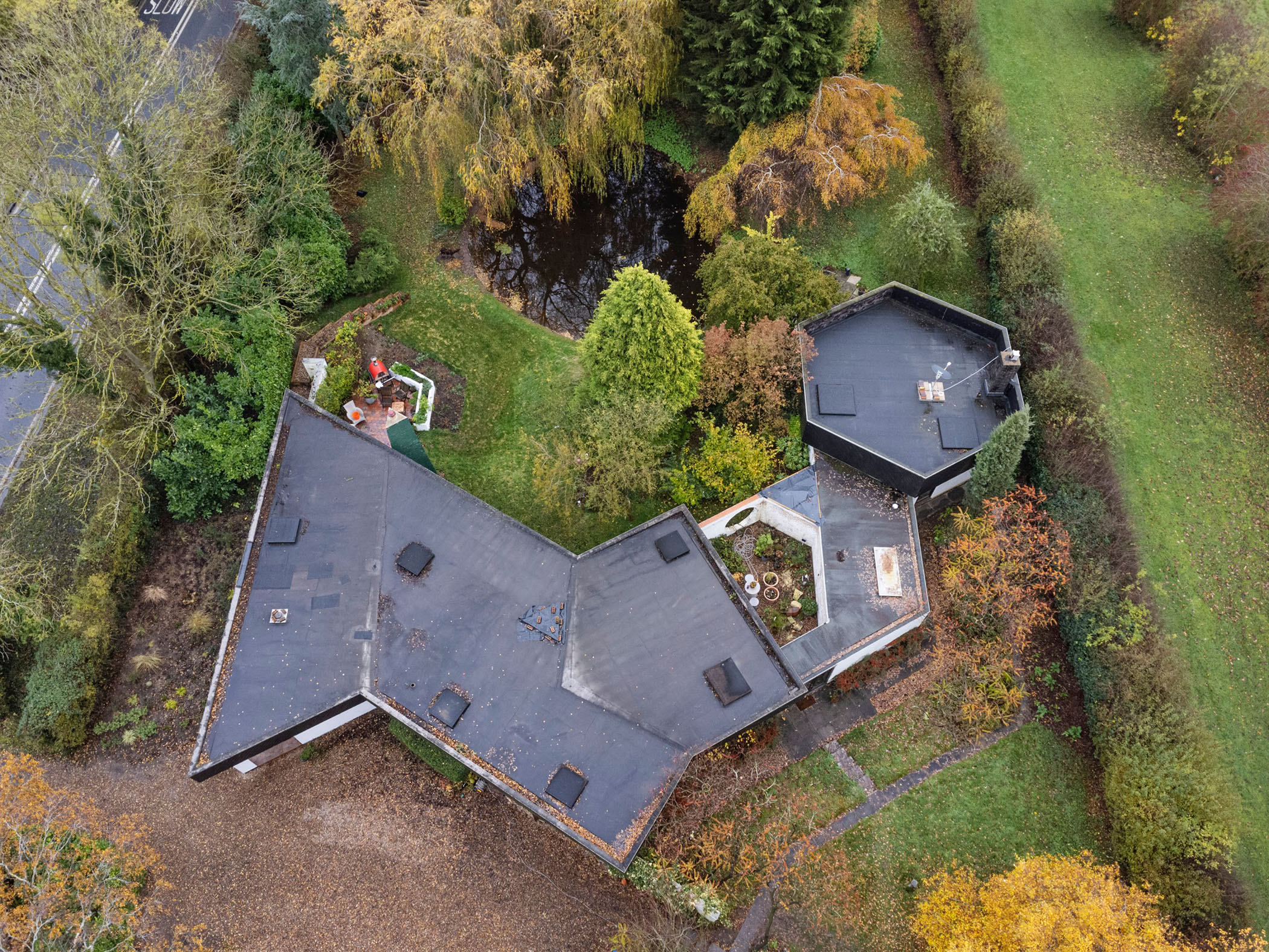 Aerial view of a modern house, including a detached garage and gardens