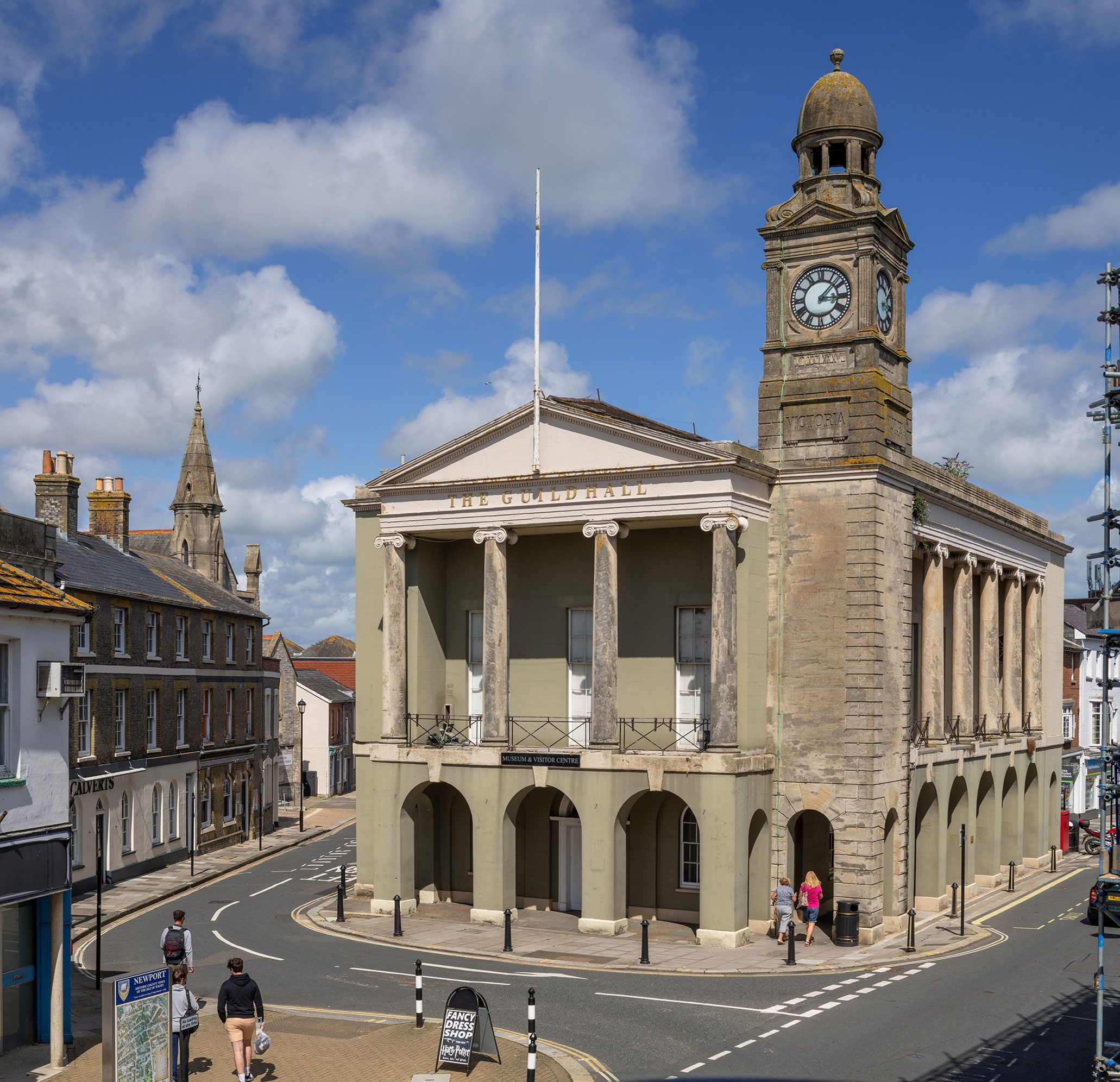 Modern colour photograph of a two-storey building with Ionic pediment and clock tower.