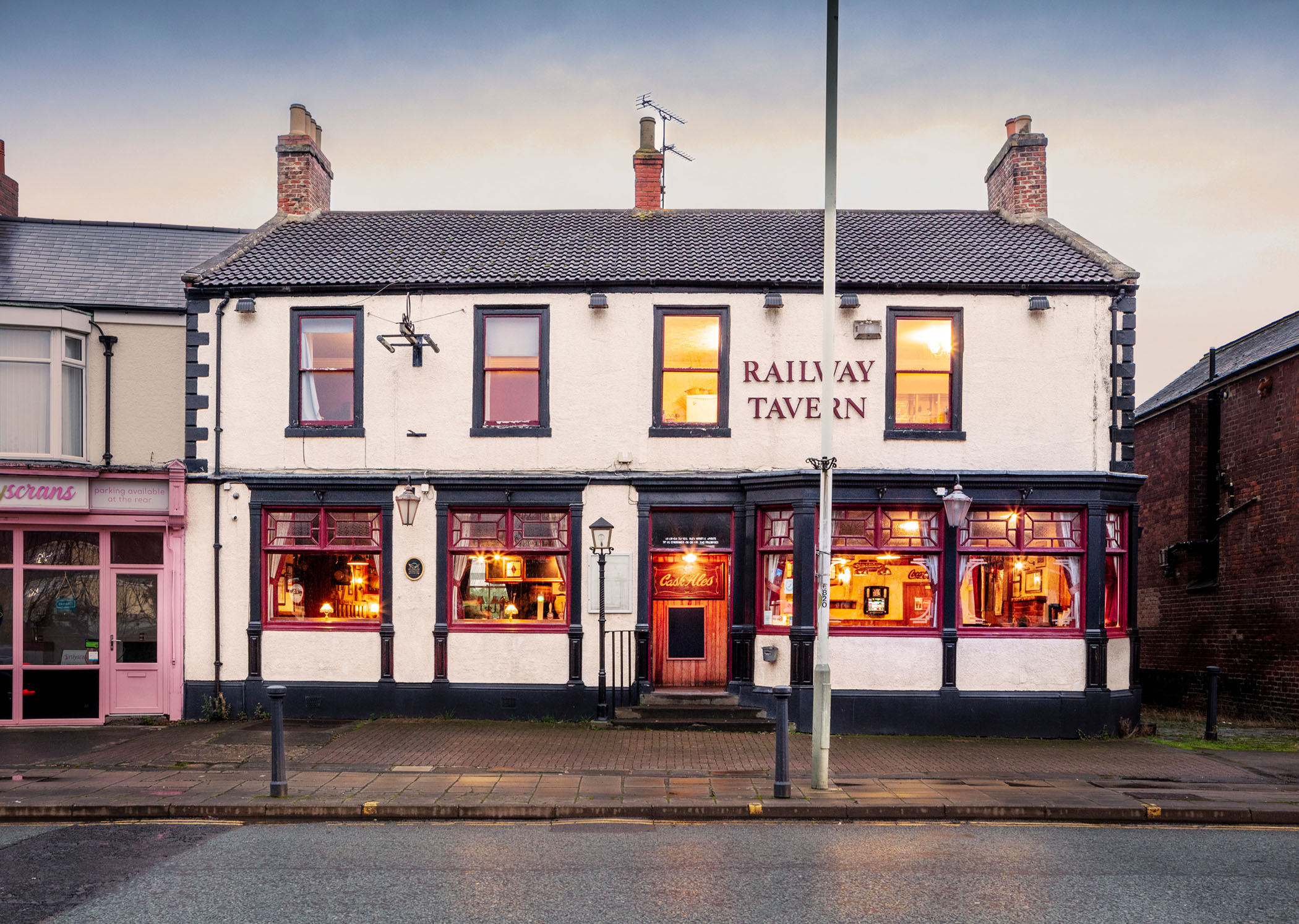 General view of a public house lit at twilight