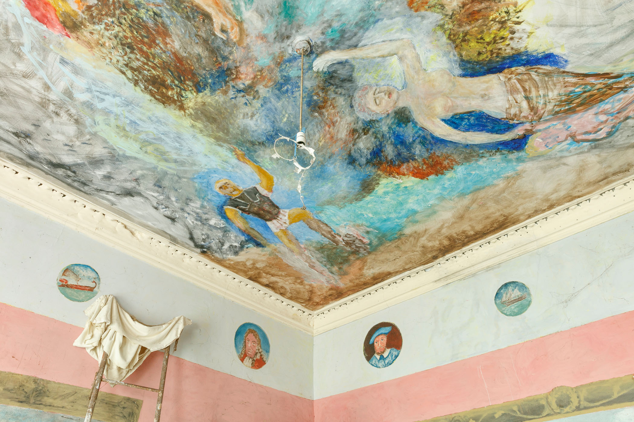 A close-up photograph of a ceiling with a painted mural.