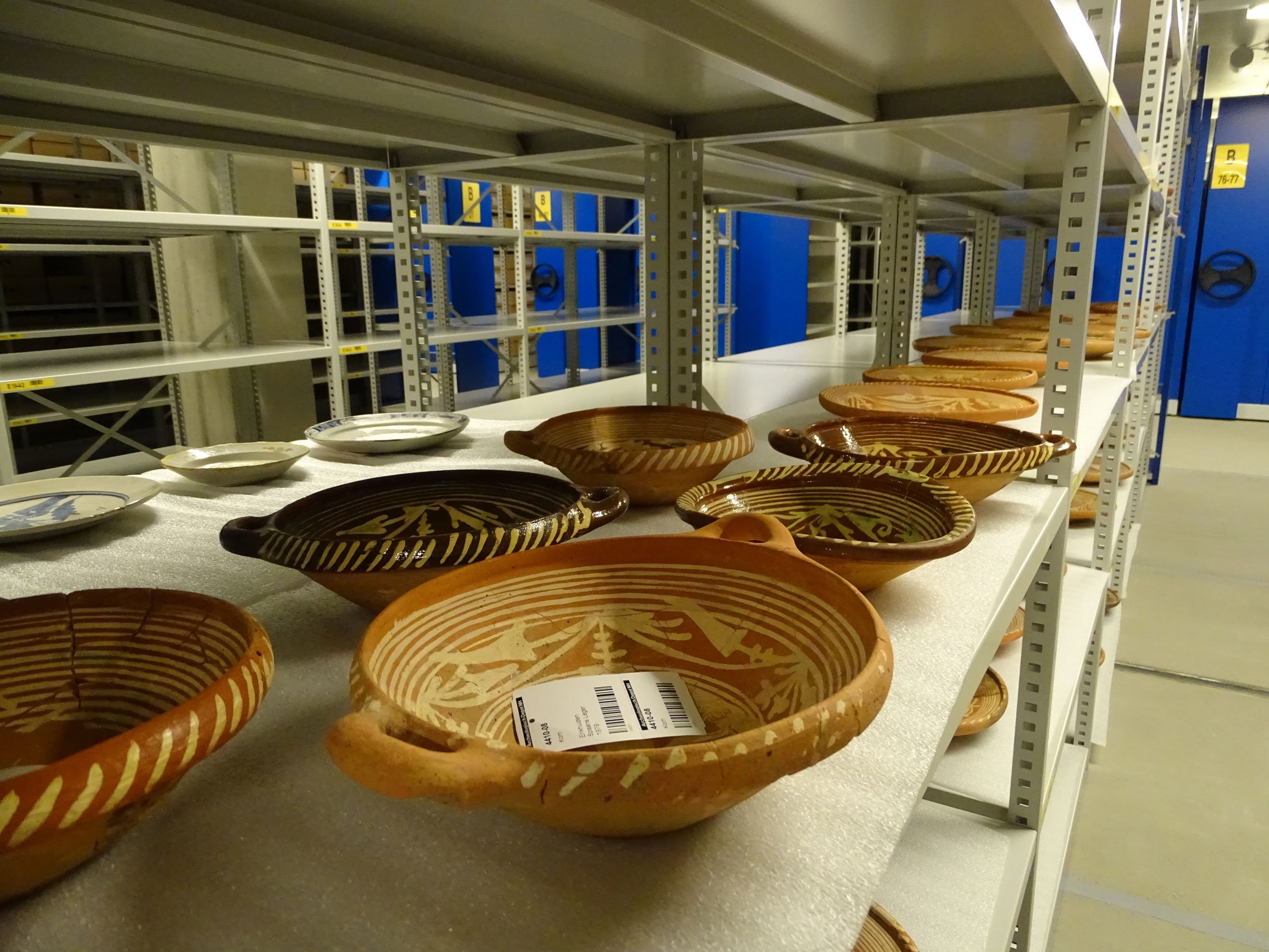 Ceramic vessels on a shelf in an archaeological store.