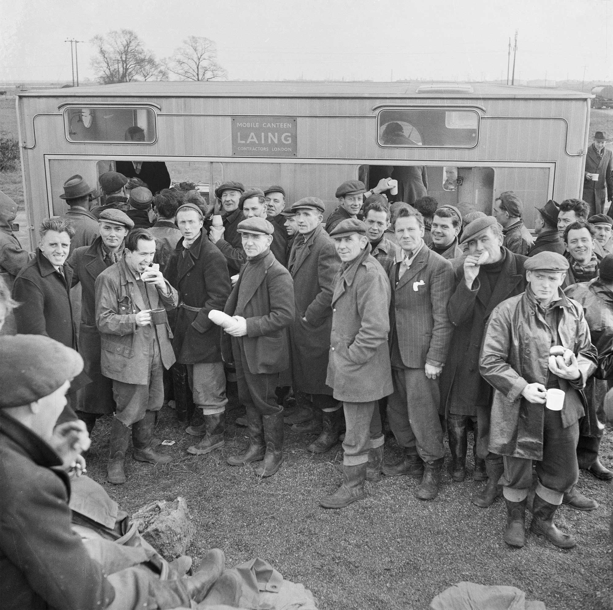 Workers queuing outside a mobile canteen